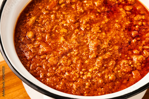 Close-up of fresh BOLOGNESE SAUCE in a white saucepan. High angle view.