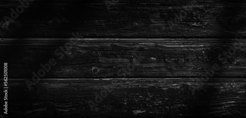 Dark burnt wooden wall. Wide panoramic black background with space for design. Web banner, website header