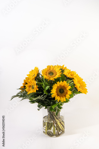 Sun flower bouquet in a glass vase in isolated white background