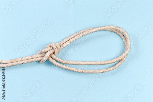 Rope knot bowline on a bight on a blue background