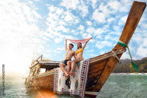 Asian couple lover travel and relax in they honeymoon trip on the wooded boat