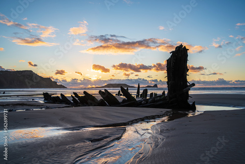 Wreck of Helvetia at sunset, Rhossili Bay beach, no people. Gower Peninsula, South Wales, the United Kingdom, UK GB.