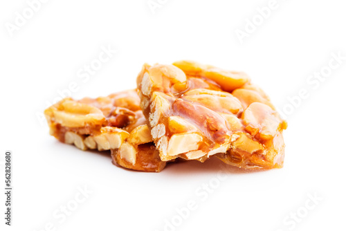 Sweet peanut brittle. Tasty peanuts in caramel isolated on white background.