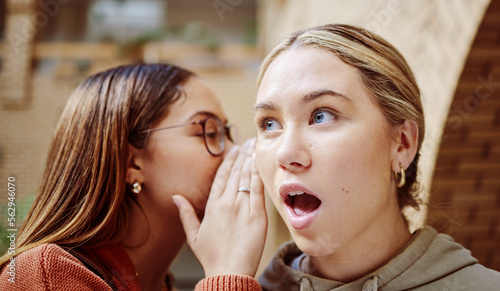 Women gossip, surprise and friends with secret in university campus. Face wow, hands and female students whisper shocking info, gossiping or sharing rumor, secrets or story and chatting in college.