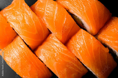 Close-up top view of bright Philadelphia sushi rolls with bright smoked salmon