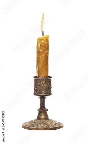 Burning old candle vintage bronze candlestick isolated on a transparent background