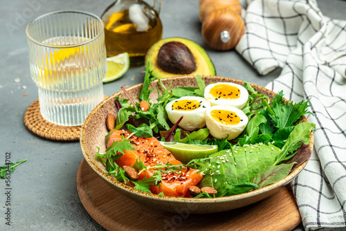 Salmon fillet with fresh salad, grape, eggs and avocado. set of healthy food for keto diet