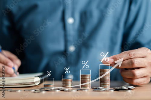 Businessman stacking money coins accounting for increase financial interest rate and business investment growth from dividend, Business Finance and Money, Save money for prepare in the future.