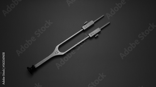 tuning fork C 128 on a grey background with gradation