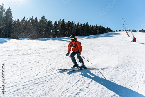 A boy skiing down a large ski slope.