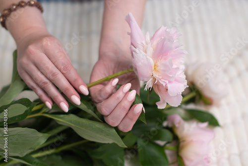 girl's hands with a beautiful pink manicure design,pastel color, gently, flowers