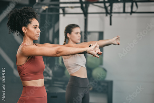 Training, stretching and friends with women in gym for training, workout and exercise. Teamwork, health and personal trainer with girl and muscle warm up for wellness, sports and progress goals