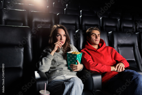 A young couple in the cinema at the premiere of the film. Only two people in the cinema, VIP screening