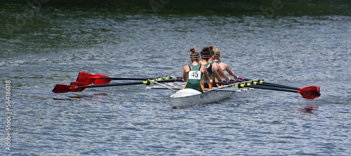 Ladies Fours Sculling Team Rowing on River.