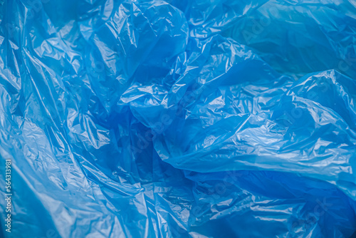 Texture and background of a blue plastic bag. Blue disposable plastic bag. Environmental problems, recycling, waste.