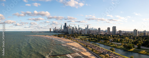 Beautiful aerial panorama view of the downtown Chicago skyline from above the water of Lake Michigan near Lake Shore Drive and South Lagoon in Lincoln Park with blue sky and fluffy white clouds above