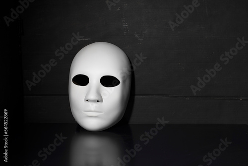 Human face mask on a dark background, psychology concept. Inner personality
