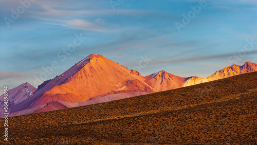 Sunrise over volcanoes on the high altitude plateau (altiplano) of the Andes mountain range, Lauca National Park, Chile