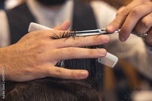 Close up of hairdressers hands cutting hair