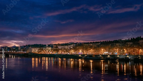 night view of Lyon city over the Saône at sunset time