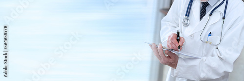 Doctor taking notes on clipboard; panoramic banner