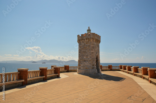 View of Piombino, piazza Bovio lighthouse and Elba Island. Maremma Tuscany Italy. On a bright sunny summer day. Copy space for text.