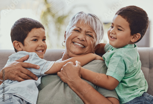 Love, grandmother and boys on couch, smile and playful on weekend, bonding and loving together. Granny, grandkids and male grandchildren on sofa in lounge and happiness on summer vacation or carefree