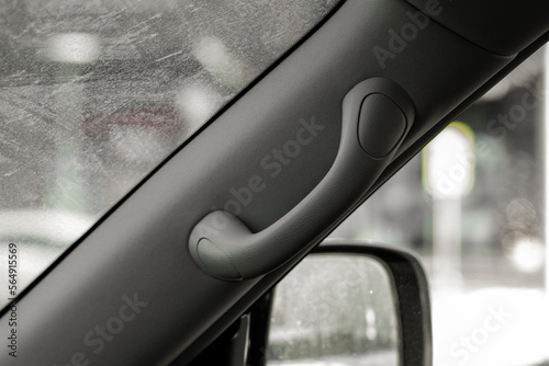 Modern car grab handle, car interior details. Car grab handler for the passenger. Car ceiling handle.