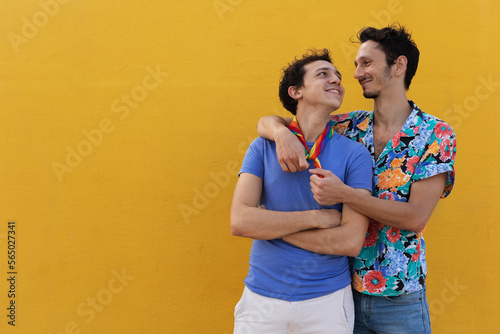 Happy young couple embraces. Two men enjoy outside.