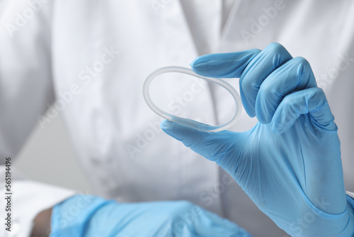 Doctor holding diaphragm vaginal contraceptive ring, closeup