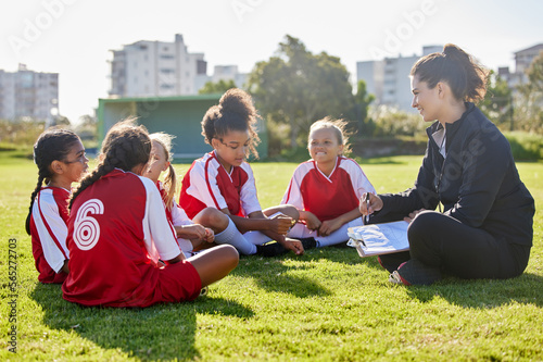 Clipboard, soccer or coach with children planning for strategy, training or sports goal in Canada. Team building, friends and woman coaching group of girl on football field for game, match or workout