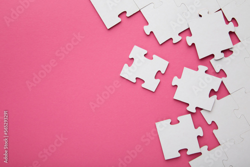 Close-up of a pile of uncompleted elements of a white puzzle. A huge number of rectangular pieces from one large white mosaic