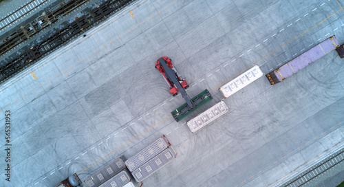 Aerial top down view crane loading container from container truck to container train, Cargo train with freight train container, Business import export logistic and transportation railway.