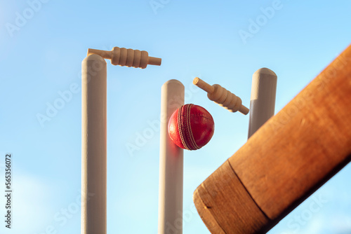 Cricket ball hitting wicket stumps knocking bails out