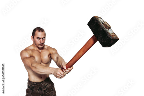 Strong man with naked torso who strikes with a sledgehammer while isolated on white background