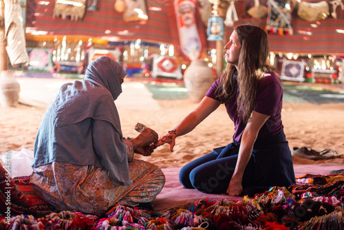 Woman getting henna at a bedouin tent