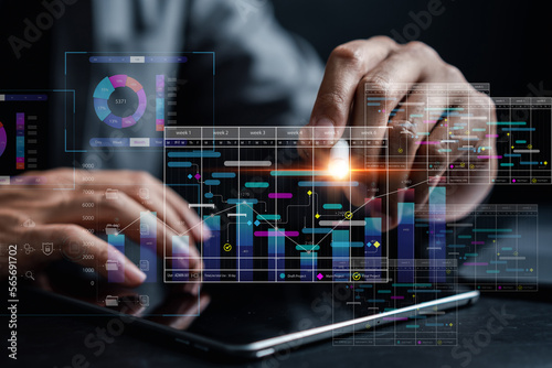 Analyst working with computer in Business Analytics and Data Management System to make report with KPI and metrics connected to database. Corporate strategy for finance, operations, sales, marketing.