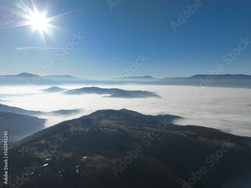 Aerial View. Flying over the high mountains in beautiful clouds. Aerial Drone camera shot. Air pollution clouds over Sarajevo in Bosnia and Herzegovina. 