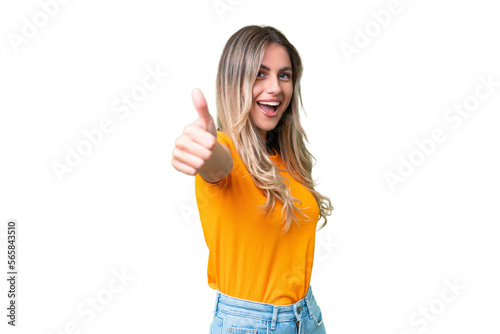 Young Uruguayan woman over isolated background with thumbs up because something good has happened