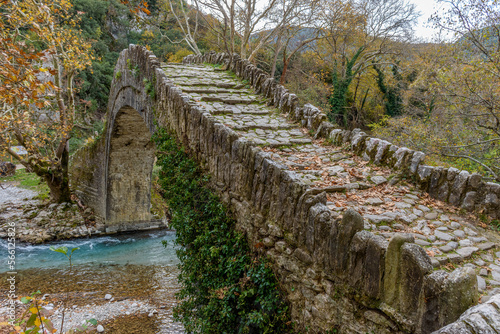 Old stone bridge in Klidonia during fall season. This arch bridge was built in 1853 and it is situated on the river of Voidomatis in Zagori, Epirus Greece.