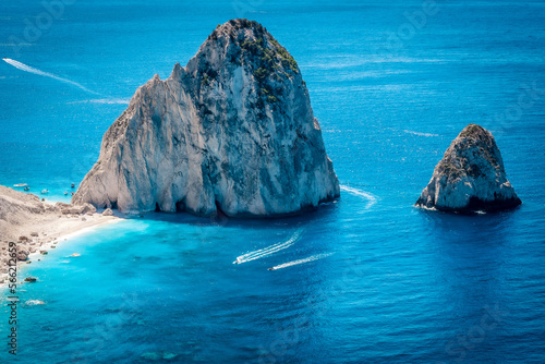 Two boats passing by Myzithres beach, a secluded headland with sandy beach, one of the most beautiful spots on the island of Zakynthos, Greece