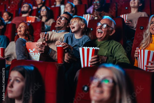 Happy senior man with grandchild in cinema.