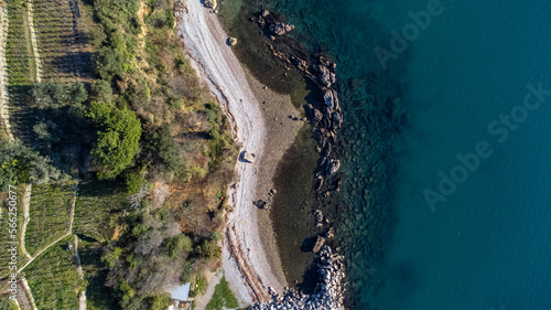 Fantastic landscape taken from the drone at the top of the cliff. Trieste, Italy. Clear sea and blue sky. Rocks and sand.