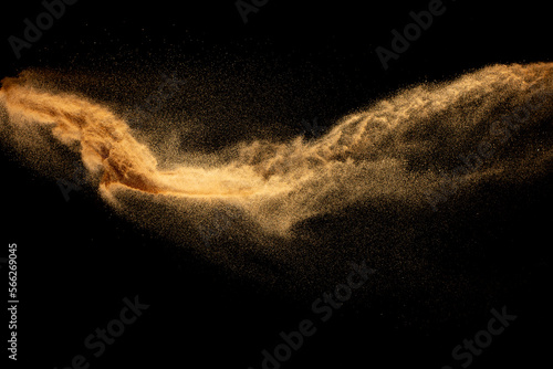 Dry river sand explosion.Brown color sand splash against black background.