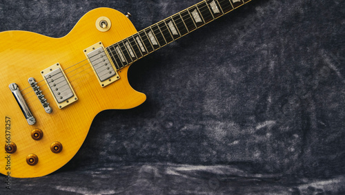 Yellow Les Paul electric guitar on a fur background