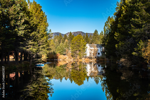 A traditional house reflecting off the water in South Lake Tahoe, CA.