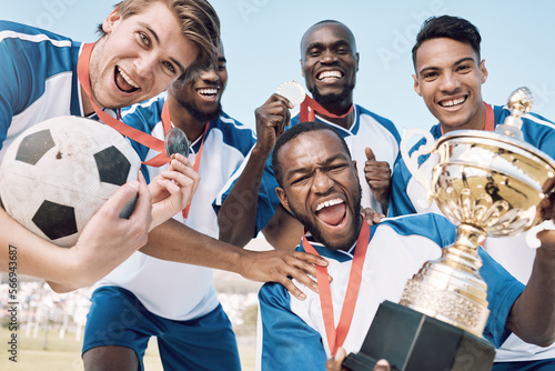 Soccer, trophy and men team winning portrait at sports competition or game with teamwork on a field. Football champion group people with medal or prize for goal, performance and fitness achievement
