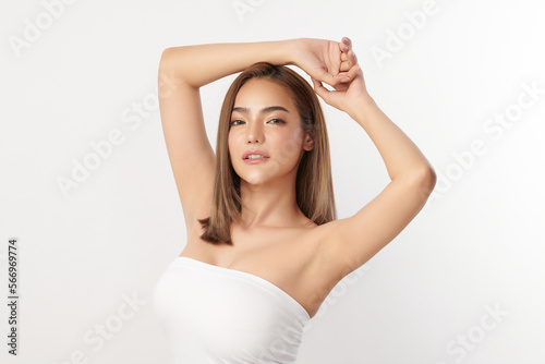 Beautiful Young Asian woman lifting hands up to show off clean and hygienic armpits or underarms on white background, Smooth armpit cleanliness and protection concept