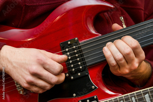 Man Playing Double Neck Fretless Electric Guitar