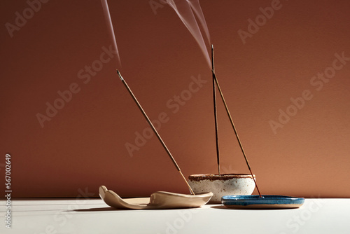 A set of burning incense for yoga or meditation. Minimalistic concept with warm colors